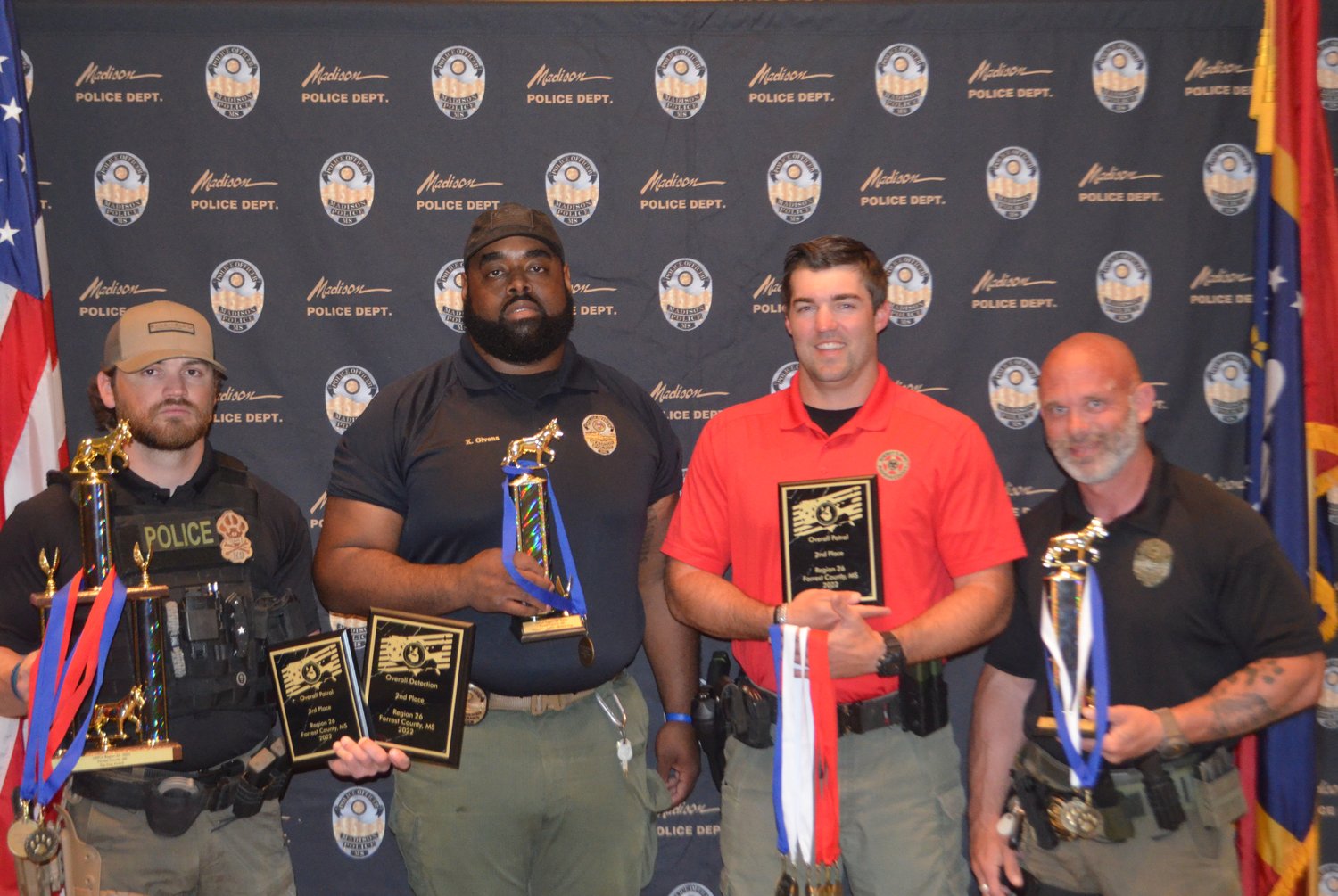 Officers from the Madison Police Department and Madison County Sheriff’s Office show off their awards from the Region 26 United States Police Canine Association Regional Trials and Certification. Pictured, from left: Investigators Lee Sanders and Karlin Givens, Deputy Conner Smith of the Madison County Sheriff’s Office, and Investigator Ricky Cross.